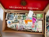 many different stamps in a wooden box on a table
