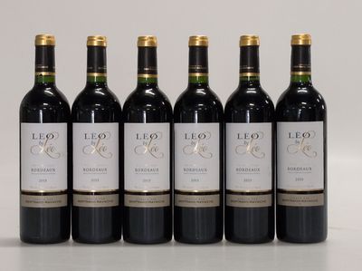 six bottles of red wine are lined up in a row