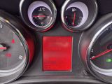 a close up of a car ' s dashboard with various gauges