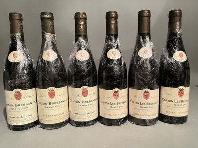 six bottles of wine are lined up in a row on a table