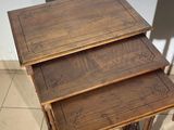 three wooden tables sitting on top of a tiled floor