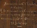 a wooden plaque with writing on it on the wall