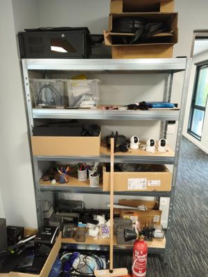 a shelf that has many items on it in the room