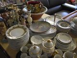 a lot of plates and bowls on the table