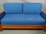 an image of a blue couch sitting on top of a wooden floor
