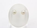a white egg with two pearl eyes on a clear stand