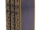 un ensemble de quatre livres anciens sur fond blanc