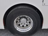a white bus that is parked on the side of the road