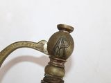 a metal hook with a handle that has a design on it