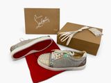 silver glittered sneakers with white soles and a red box