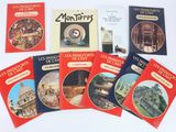 six books on a white table with pictures of buildings and buildings