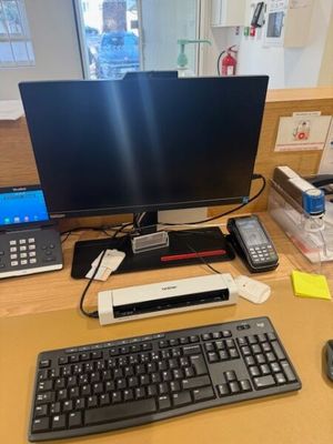a computer desk with a keyboard and a monitor on it