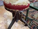 a small stool with a red seat in a living room