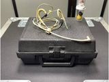 an image of a suitcase on a table with ear buds in it