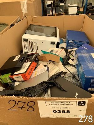 a cardboard box filled with electronic equipment and other items