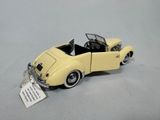 a yellow toy car with a tag attached to it
