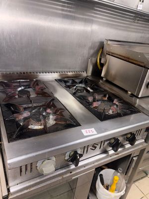 stainless steel stove top with two burners and a toaster oven