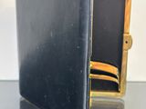 a black and gold wallet sitting on top of a table