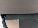 a laptop sitting on top of a stand on a table