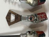 three different types of cork openers on a white surface