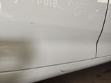 a white car that has a sticker on the side of it