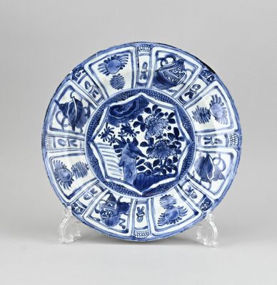 a blue and white plate with a circular design on it