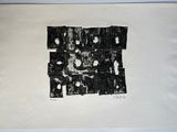 black and white photograph of a piece of paper with torn pieces on it