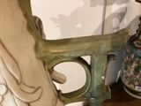a vase that is sitting on a table with a vase in the background