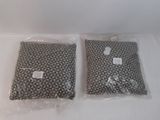 two bags of pillows sitting on a white surface