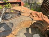 a rusted guitar sitting in the middle of a field