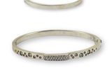 two silver bang bracelets with black and white diamonds