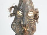 a statue of a man with a fish in his mouth