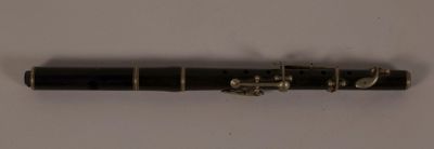 a black pen that is laying on a white surface