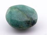 an image of a close up of a green stone on a white surface