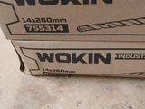 two boxes of wokin tools sitting on the floor in a room