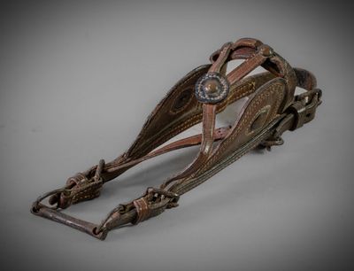 brown leather dog harness with metal buckles and a metal buckle
