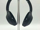 a pair of headphones on a stand on a white surface