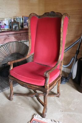 a red chair with a red cushion in a room