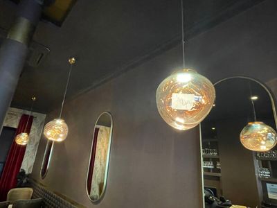 many lights hanging from the ceiling in a restaurant
