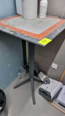 a small table with a cup on it in a room