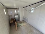 a room with a table and a refrigerator in it