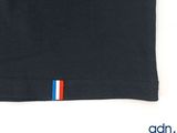 a close up of a black shirt with a red, white, and blue stripe on it