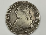 a silver coin with a woman ' s profile on it