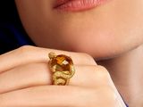 close up of a woman ' s hand with a ring on her finger