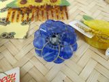 a blue flower sitting on top of a table next to other items