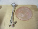 a bowl and a spoon sitting on a table next to a glass