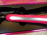 a pink hair dryer in a pink box on a table