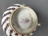 a cup and saucer sitting on top of a saucer