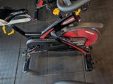 a stationary exercise bike in a gym room with other equipment
