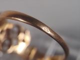 a close up of a gold ring with a diamond on it